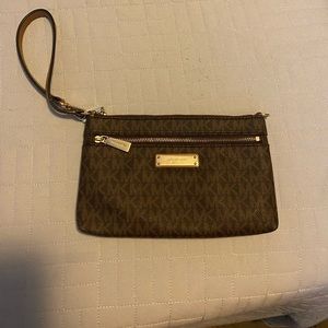 Michael Kors small logo wristlet. 8’ wide, 5’ high.